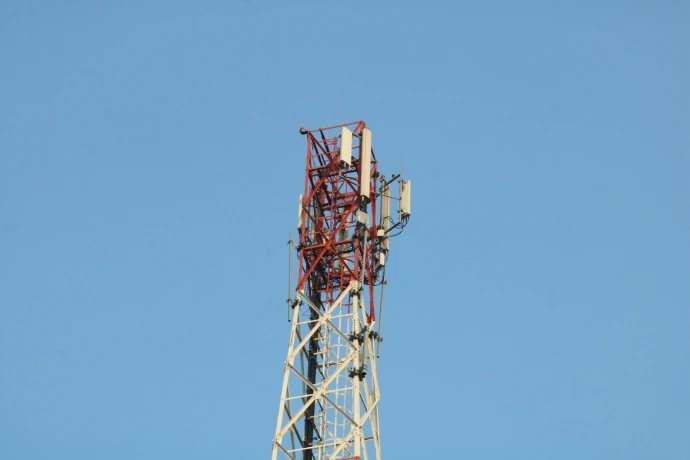 a cell phone tower with a blue sky in the background
